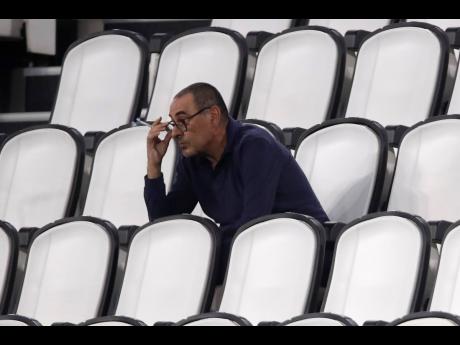 In this  Saturday, August 1, 2020 photo, Juventus’ then head coach Maurizio Sarri smokes during a Serie A match between Juventus and Roma, at the Allianz stadium in Turin, Italy. Sarri was fired by Juventus yesterday.