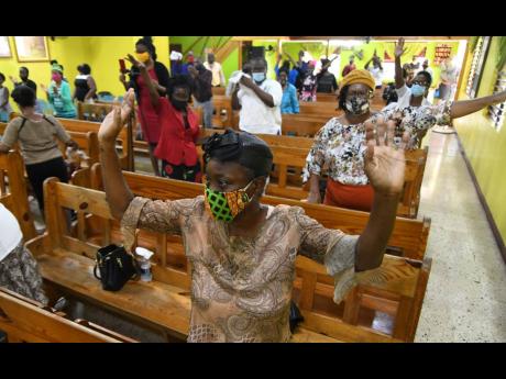 Worshippers at Shiloh Apostolic Church wear masks and observe social distancing during the Sunday service at Church Street in Kingston. 