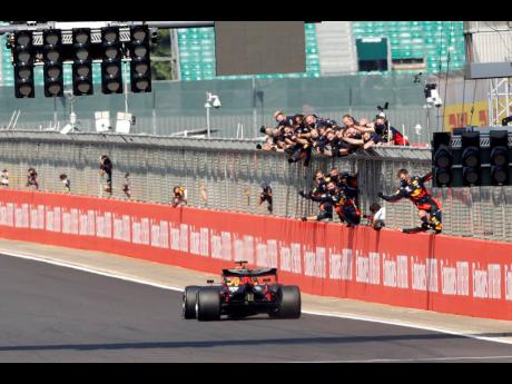 Red Bull driver Max Verstappen of the Netherlands approaches the finish line to win the 70th Anniversary Formula One Grand Prix at the Silverstone circuit at Silverstone, England yesterday.