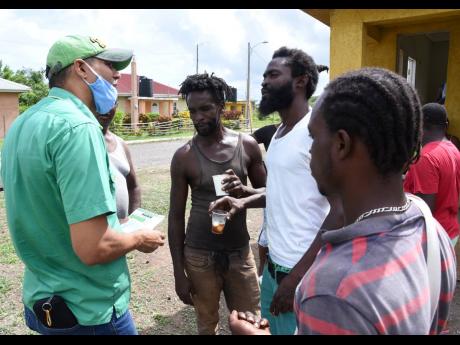 Kent Gammon (left), Jamaica Labour Party standard-bearer in Clarendon South Western, speaking with residents of Springfield during a walkthrough on Saturday, August 1.