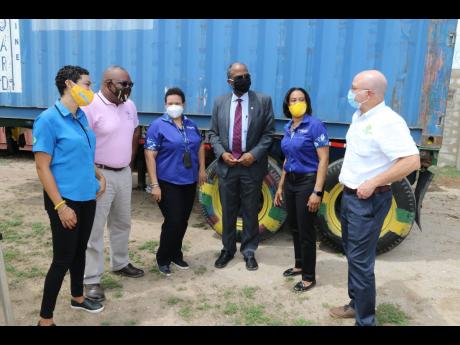 Health measures were observed at the presentation as (from left) Simone Pearson, group general counsel/company secretary, Jamaica Producers Group, Michael Leslie, financial manager, Jamaica Cancer Society, Corah-Ann Robertson-Sylvester, chief executive off