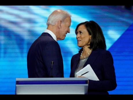 In this September 12, 2019, file photo, Democratic presidential candidate Joe Biden speaks with then candidate Senator Kamala Harris. Biden confirmed on Tuesday that she would be his running mate. 