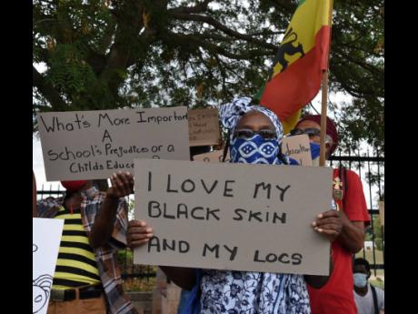 Rastafarians demonstrate in front of the Ministry of Education headquarters at National Heroes Circle, Kingston, on Tuesday to protest discrimination against the wearing of locked hair in schools. The protest was sparked by the July 31 Supreme Court ruling