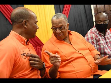 Peter Bunting (left), co-campaign director, chats with PNP President Dr Peter Phillips at a party meeting at The Mico University College on Marescaux Road in Kingston on  Sunday, June 28.