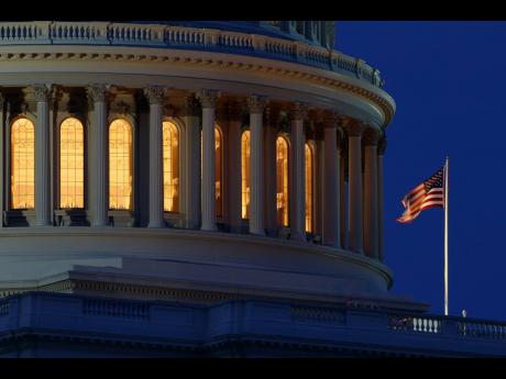 The American flag flies on the Capitol Dome in Washington.