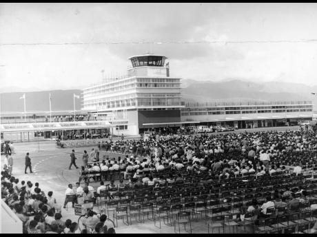 A section of the large gathering that attended the official opening of the new Palisadoes Airport on July 27, 1961. In the background is part of the terminal building showing the control tower and administrative offices.