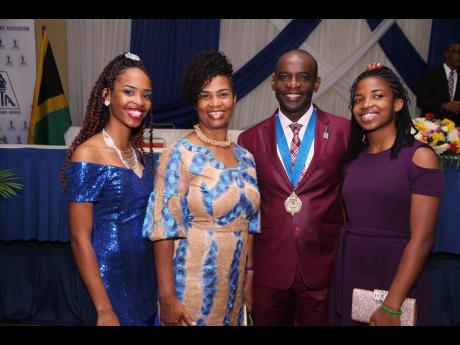 New Jamaica Teachers’ Association President Jasford Gabriel with his family at his installation ceremony on Monday at Hilton Rose Hall. From left: Shara (daughter), Sharon (wife) and Amanda (daughter). 