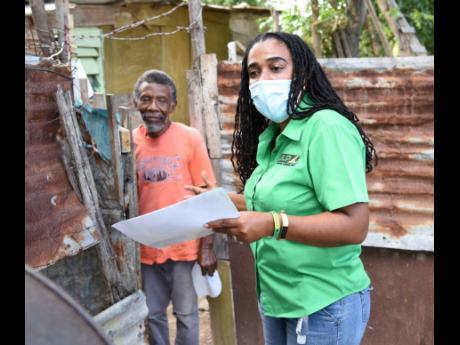 Natalie Campbell-Rodriques, Jamaica Labour Party candidate for St Catherine North Central, greets a resident in a section of the constituency recently.