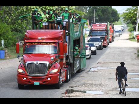 A JLP motorcade makes its way along Bustamante Highway while prime minister and party leader Andrew Holness toured several Clarendon constituencies on Friday.
