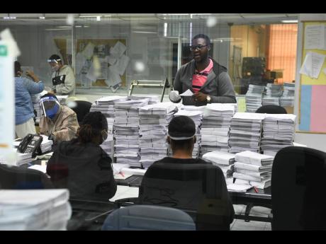 Electoral Office of Jamaica staff and volunteers preparing ballots in a sterile area at the Duke Street offices in Kingston on Sunday. It is expected that all 1.9 million ballots will be printed and ready by Wednesday, August 26.