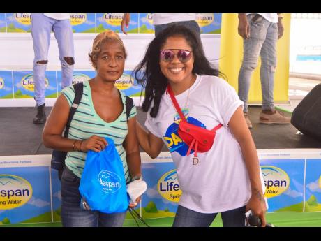 Jacquiline Miller (right) poses for a picture after receiving her Lifespan goodie bag from Brand Ambassador Denyque. 