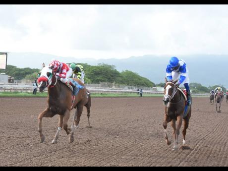 
ABOVE AND BEYOND (left), with Dane Nelson aboard, wins the 2020 Jamaica Oaks at Caymanas Park yesterday ahead of ANOTHER AFFAIR (Robert Halledeen). The winner is trained by Anthony Nunes.