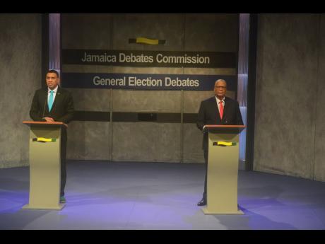 People’s National Party President Dr Peter Phillips (right) and Jamaica Labour Party Leader Andrew Holness match wits and make pitches to woo voters in the Jamaica Debates Commission-hosted leadership debate last night.
