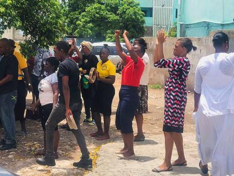 Members of City of Refuge Endtime Prophetic Ministries gather yesterday along Darling Street, Kingston. 