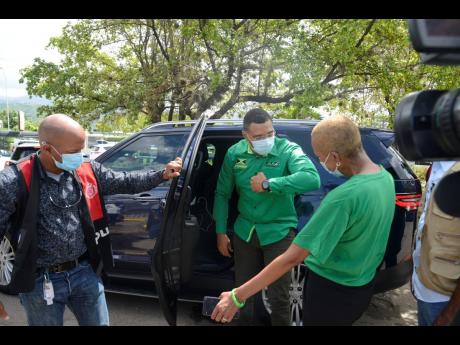 Prime Minister Andrew Holness greets Fayval Williams at the Mona High School, where they voted, on September 3, 2020. Holness led the Jamaica Labour Party to a landslide victory at the polls on Thursday.