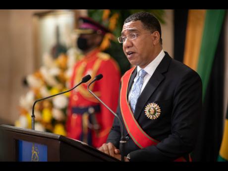 Prime Minister Andrew Holness addresses the gathering during his swearing-in ceremony held at King’s House, St Andrew on Monday.