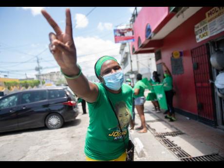 A Jamaica Labour Party (JLP) supporter displays the iconic V-sign on nomination day, August 18, in the St Andrew East Central constituency. Preliminary data show that People’s National Party incumbent Dr Peter Phillips defeated the JLP’s Jodian Myrie b