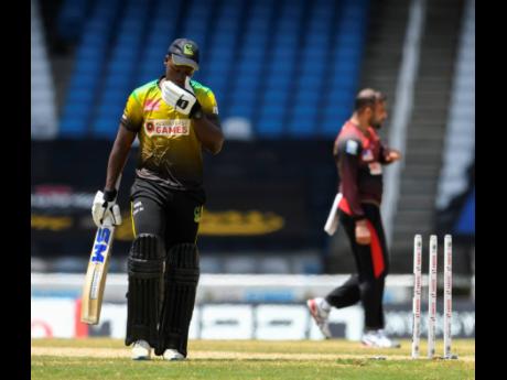 Nkrumah Bonner (left) of Jamaica Tallawahs walks off the field dismissed by Fawad Ahmed (right) of Trinbago Knight Riders during the Hero Caribbean Premier League semi-final between Jamaica Tallawahs and Trinbago Knight Riders at Brian Lara Cricket Academy