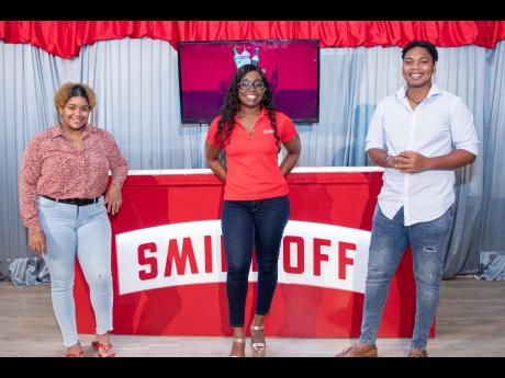 Smirnoff Brand Manager Reshima Kelly is sandwiched by UWI Marketing Association Vice- Presidents Sheyeen Leslie (left) and Alrique Welsh.