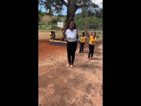 Head of the Morningside Primary and Infant School in St Elizabeth, Nahalia Lynch (foreground), engages in a physical activity session with children at the school.