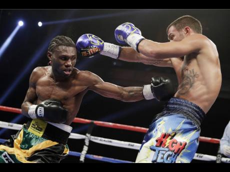 
Vasyl Lomachenko (right) of Ukraine, dodges a punch by Nicholas Walters during a WBO junior lightweight title boxing match on Saturday, November 26, 2016, in Las Vegas.