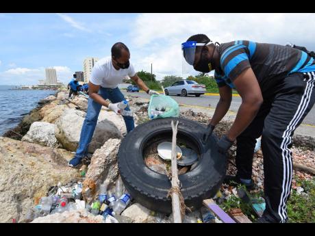 Volunteers participating in an impromptu clean-up along a section of the Kingston Harbour last Saturday.