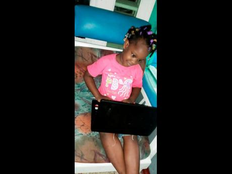 Young Mikayla uses the laptop her mother won through the Malta Back-to-School promotion to participate in distance learning using Google Classroom. 