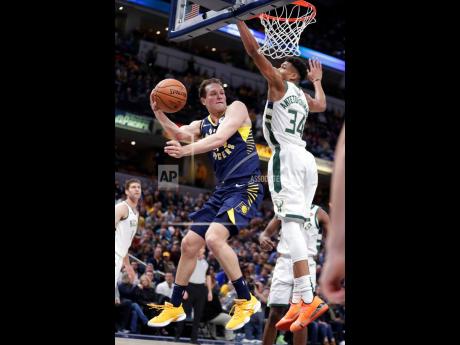 Milwaukee Bucks forward Giannis Antetokounmpo (right) attempts to block a pass by Indiana Pacers forward Bojan Bogdanovic during the first half of an NBA game in Indianapolis, Indiana, on Wednesday February 13, 2019.
