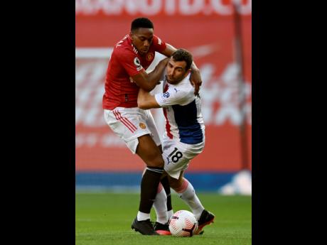 Manchester United’s Anthony Martial (left) and Crystal Palace’s James McArthur challenge for the ball during the English Premier League match between Manchester United and Crystal Palace at the Old Trafford stadium in Manchester, England, yesterday. Pa
