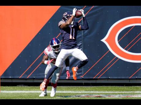 Chicago Bears wide receiver Darnell Mooney catches a 15-yard touchdown pass as New York Giants cornerback Corey Ballentine defends during the first half of an NFL football game in Chicago, Illinois, yesterday.