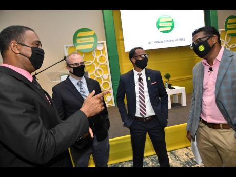 From left: SEPROD Director Christopher Gentles; Chairman P.B. Scott; Corporate Secretary and Chief Financial Officer Damion Dodd; and CEO Richard Pandohie engage in conversation yesterday at the company’s annual general meeting at The Jamaica Pegasus hot