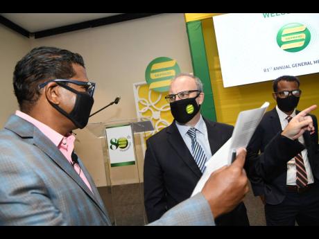 Richard Pandohie (left), chief executive officer/managing director, Seprod Limited, in discussion with P.B. Scott (centre), chairman, Seprod Limited, and Damion Dodd, chief financial officer and corporate secretary, Seprod Limited, during the company’s a