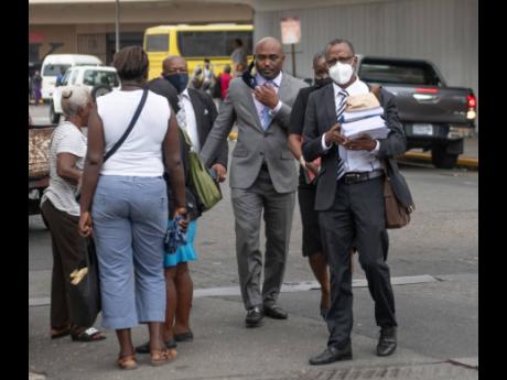 St Catherine South Central Member of Parliament Dr Andrew Wheatley (second left) and attorney-at-law Chukwuemeka Cameron (second right) make their way to the Supreme Court in downtown Kingston on Friday, August 1. 