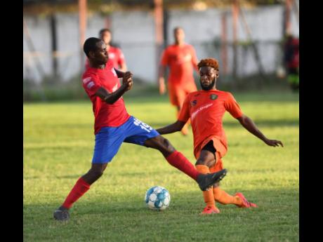 Dunbeholden’s Kevin Reid (left) puts in a challenge on Tivoli Gardens’ Jamie Robinson during a Red Stripe Premier League encounter at the Edward Seaga Sports Complex on Sunday, October 20, 2019.