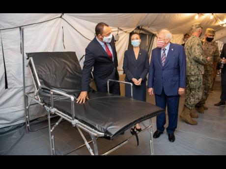 Minister of Health and Wellness Dr Christopher Tufton examines a bed at the field hospital at National Chest Hospital in Kingston on Thursday. To his left are Minister of Foreign Affairs Kamina Johnson Smith and United States Ambassador Donald Tapia. The f