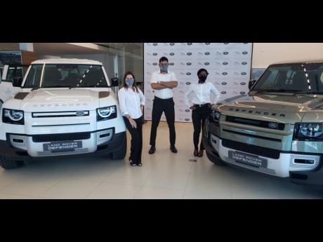 Unveiling the new Defender are (from left): Jackie Stewart Lechler, managing director, Stewart Auto Gallery; Andrew Badaloo, sales executive, Stewart Auto Gallery; and Nedita Gibson, brand manager, Stewart Auto Gallery.