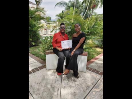 
Three-time cancer survivor and physiotherapist Josan Sutherland (right) and her mother, Carmen Walker-Sutherland, display the Chevening Scholarship award certificate.