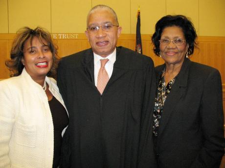Justice Sam Walker with his wife, Marie (left), and mother, Gloria Walker, following his swearing-in as judge on the New York State Supreme Court. 