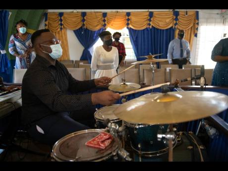 Isaac Dunkley plays the drums at the Pentecostal Gospel Showers church in Riverton City on Sunday. Dunkley, an avid participant in church, fears he will miss out on his dream of studying medicine. 