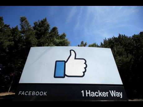 In this April 14, 2020 file photo, the thumbs up-like logo is shown on a sign at Facebook’s headquarters in Menlo Park, California.