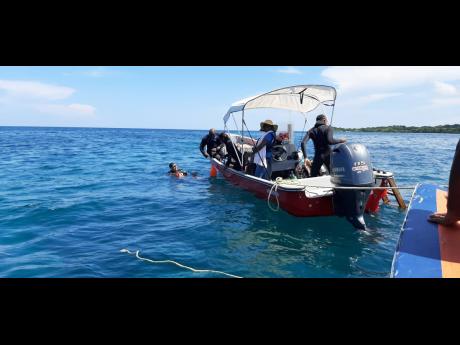 Divers from the Negril Environment Protection Trust preparing to disembark their boat for the planting corals on the seafloor of the Orange Bay Fish Sanctuary as part of rebuilding that reef area last Friday.