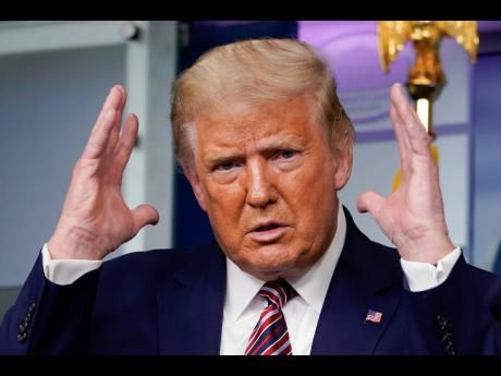 President Donald Trump gestures while speaking during a news conference at the White House on Sunday.