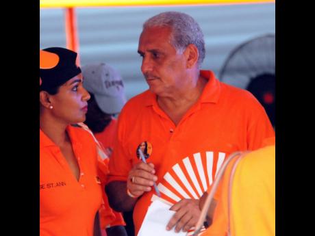 Richard Lake speaks with partner Lisa Hanna in an internal election on September 17, 2016. The couple has since got married.