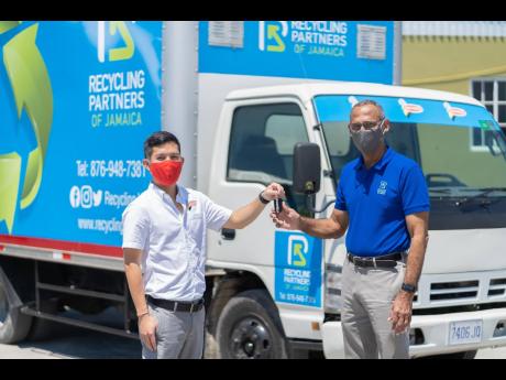 Chairman of Recycling Partners of Jamaica, Dr Damien King (right) symbolically receives the keys to the new recycling truck donated by National Baking Company, from Craig Hendrickson, director of sales and marketing at National Baking Company. 