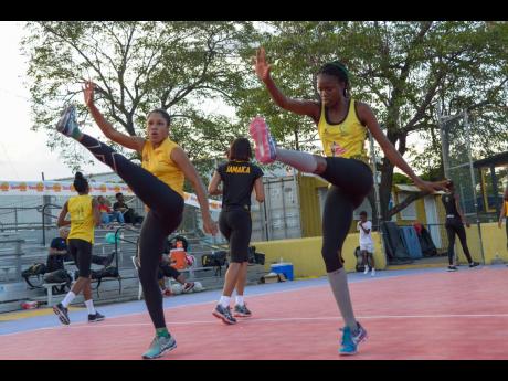 Sunshine Girls Adean Thomas (left) and Nichole Dixon go through their  paces during a recent  training session at the Leila Robinson Courts at the National Stadium.