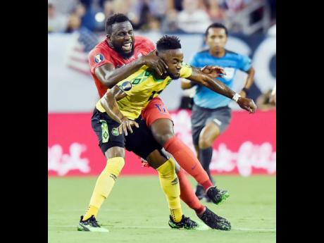 Jamaica forward Junior Flemmings (foreground) comes under a challenge from United States forward Jozy Altidore during a Concacaf Gold Cup semi-final football match in Nashville, Tennessee, on July 3, 2019. Flemmings has received flak after allegedly using 