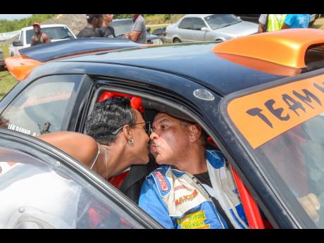 Driver Ian Banks gets a kiss from his wife Kedesha after completing a gruelling race at Dover.
