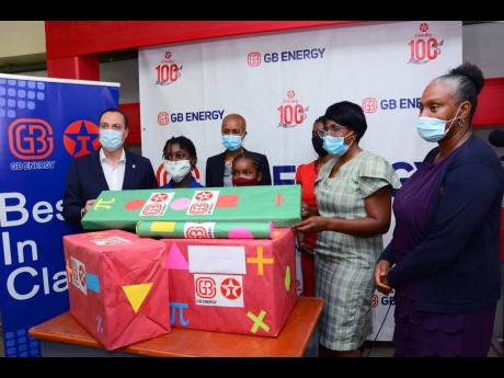 
Jennifer Solomon, principal of August Town Primary School, accepts J$100,000 worth of Math Resources from Bela Szabo, CEO of GB Energy Texaco Jamaica. Looking on from (from left) are: Esther Roxborough, student of the school;  Fayval Williams, Minister of