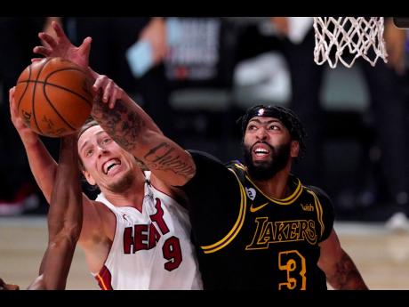 
Miami Heat forward Kelly Olynyk (number 9) and Los Angeles Lakers forward Anthony Davis compete for control of a rebound during the second half of Game 2 of the NBA Finals, on Friday. The Lakers won 124-114.