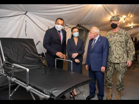 
From left: Health and Wellness Minister Dr Christopher Tufton touring the COVID-19 field hospital on the grounds of the National Chest Hospital with Foreign Affairs Minister Kamina Johnson Smith, United States Ambassador Donald Tapia, and Admiral Craig Fa